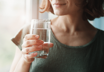 woman holding a glass of water